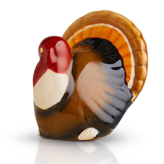 Glass sculpture of a rooster with a shell on a white background