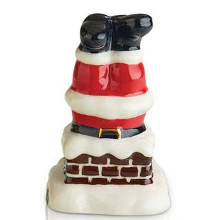 Decorative salt and pepper shaker set shaped like a dog in Santa Claus outfit on a white background