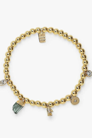 Gold beaded bracelet with charms on a white background