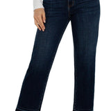 Dark blue jeans worn by a person on a white background