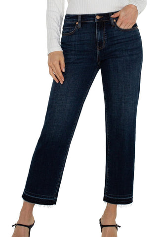 Dark blue jeans worn by a person on a white background