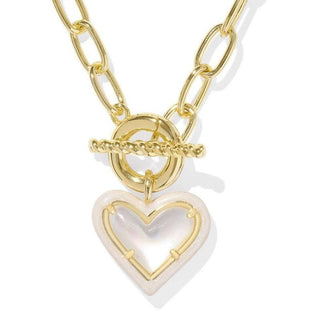Gold necklace with a heart-shaped pendant on a white background