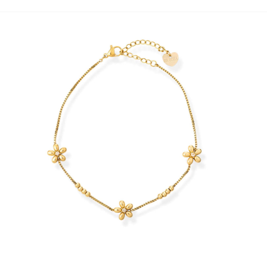 Gold bracelet with floral charms on a white background