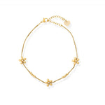 Gold bracelet with floral charms on a white background