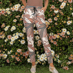 Floral patterned pants worn by a person on a white background