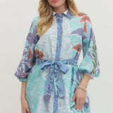 Woman wearing a floral dress with a white background