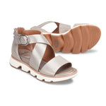 Silver sandal with a brown sole on a white background