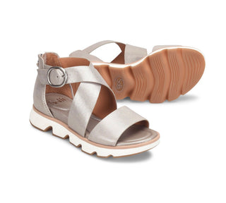 Silver sandal with a brown sole on a white background