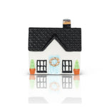 House-shaped container with a black roof and white body on a white background
