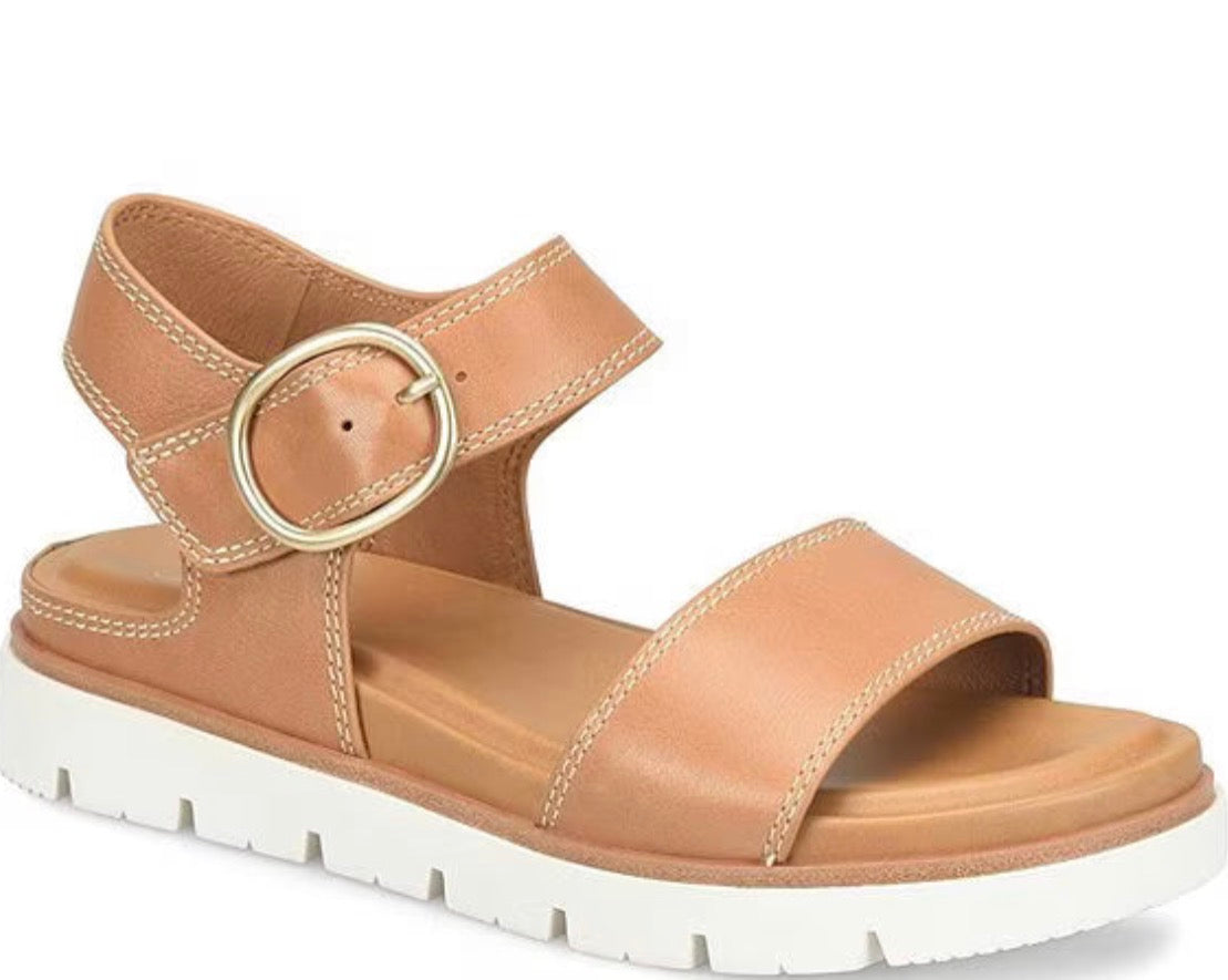 Tan sandal with a gold buckle on a white background