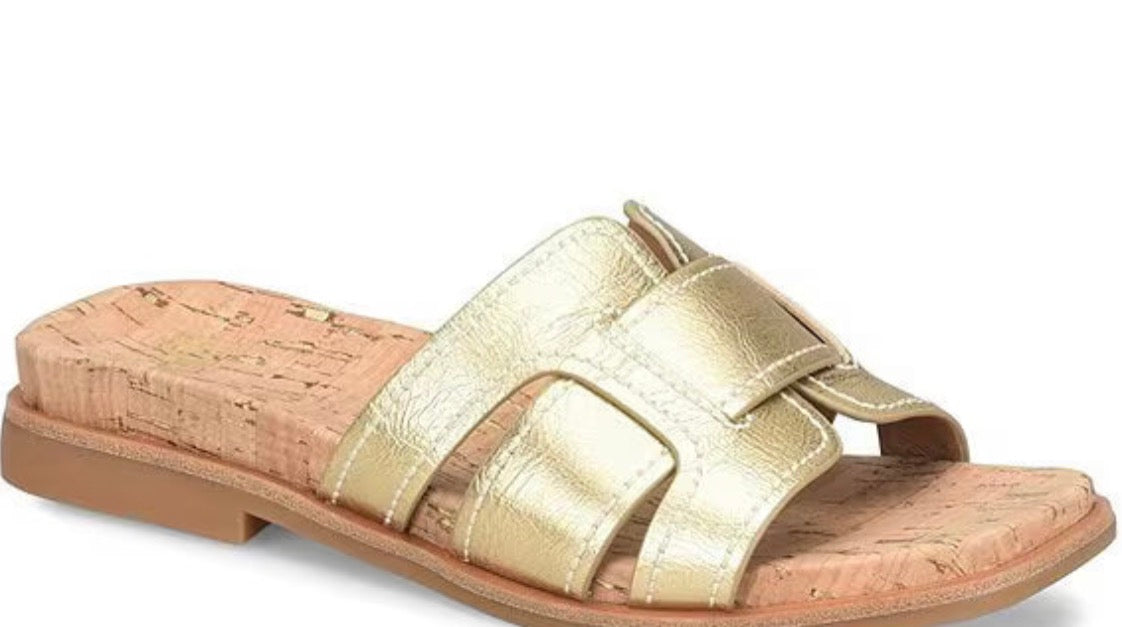 Gold sandal with cork sole on a white background