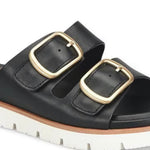 Black sandal with gold buckles on a white background