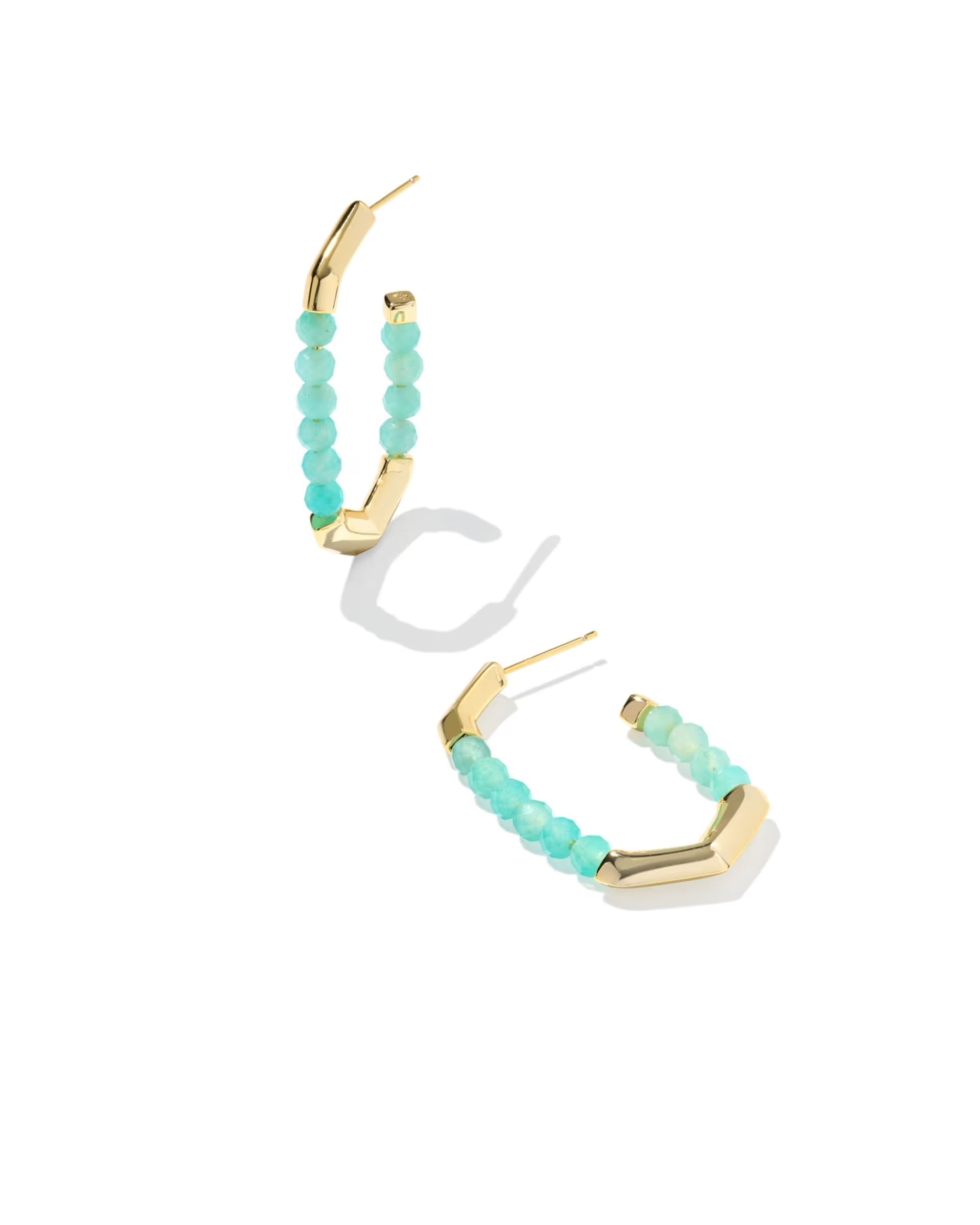 Turquoise beaded hoop earrings with gold accents on a white background