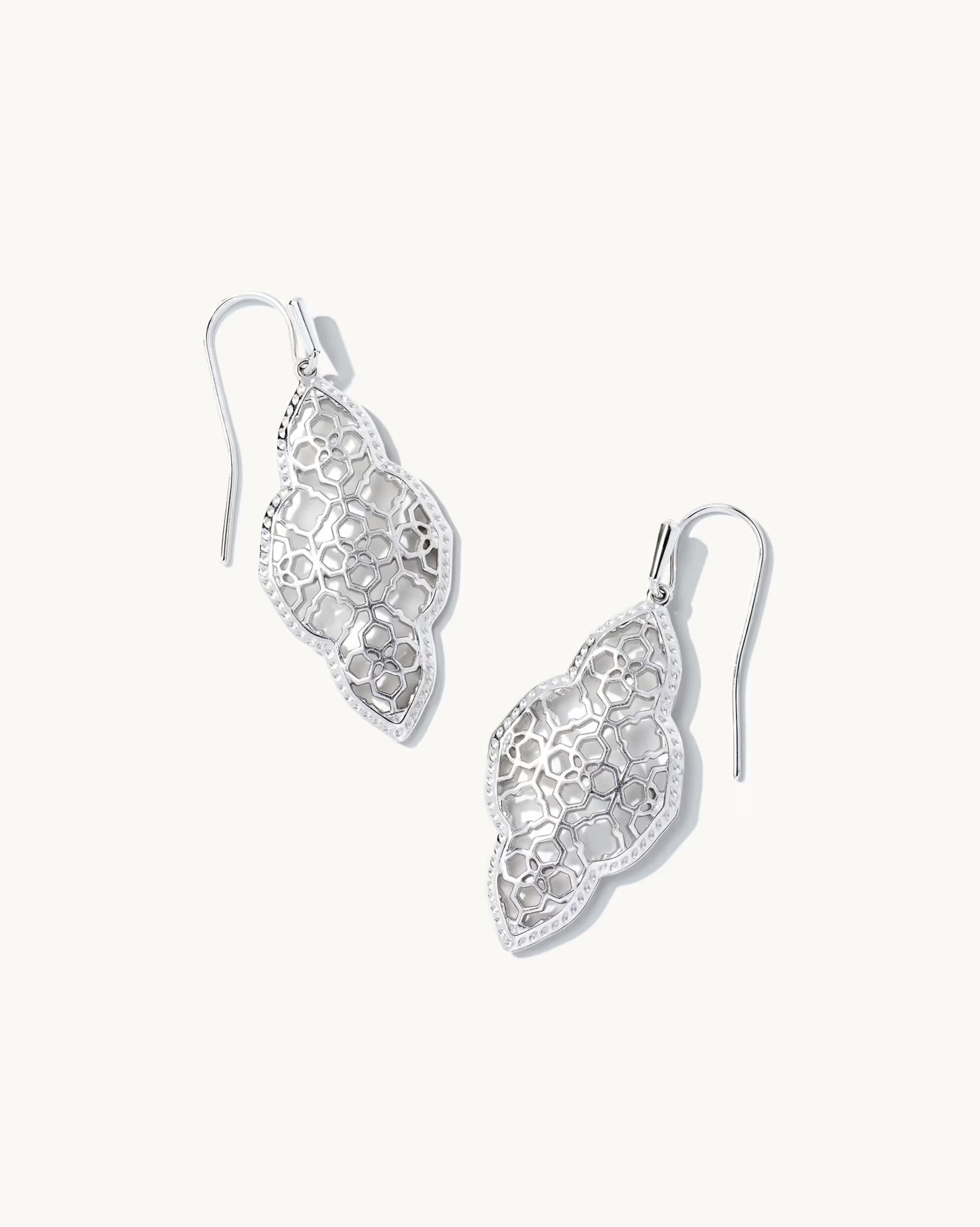 Pair of silver earrings on a white background