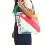 TOTE BAG in bright colors on woman’s shoulder