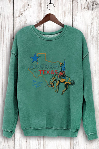 Green sweatshirt with Texas graphic on a wooden hanger against a wooden background