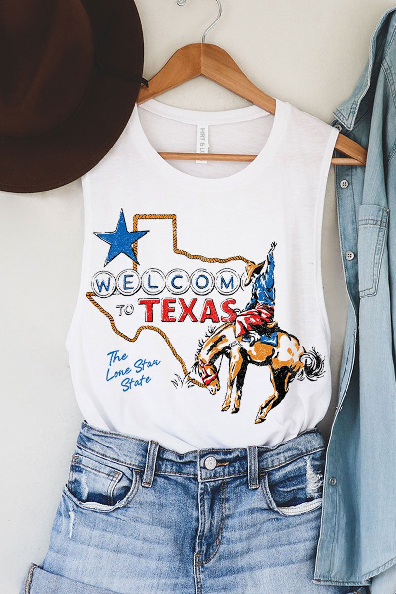 White tank top with 'Welcome to Texas' graphic, cowboy hat, and denim jacket on a hanger.