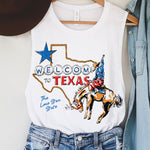 White tank top with 'Welcome to Texas' graphic, cowboy hat, and denim jacket on a hanger.