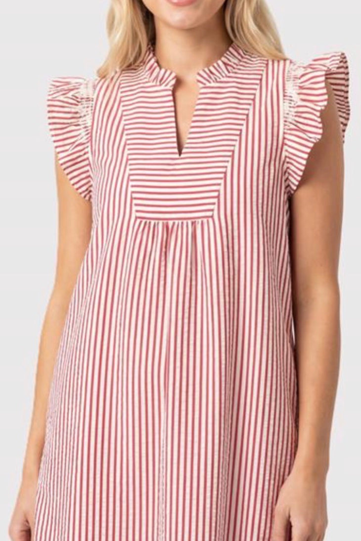 Woman wearing a red and white striped dress on a white background