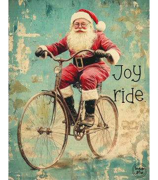 Vintage-style Christmas art print featuring Santa Claus riding a bicycle with the words 'Joy ride.' on a distressed teal and cream background.
