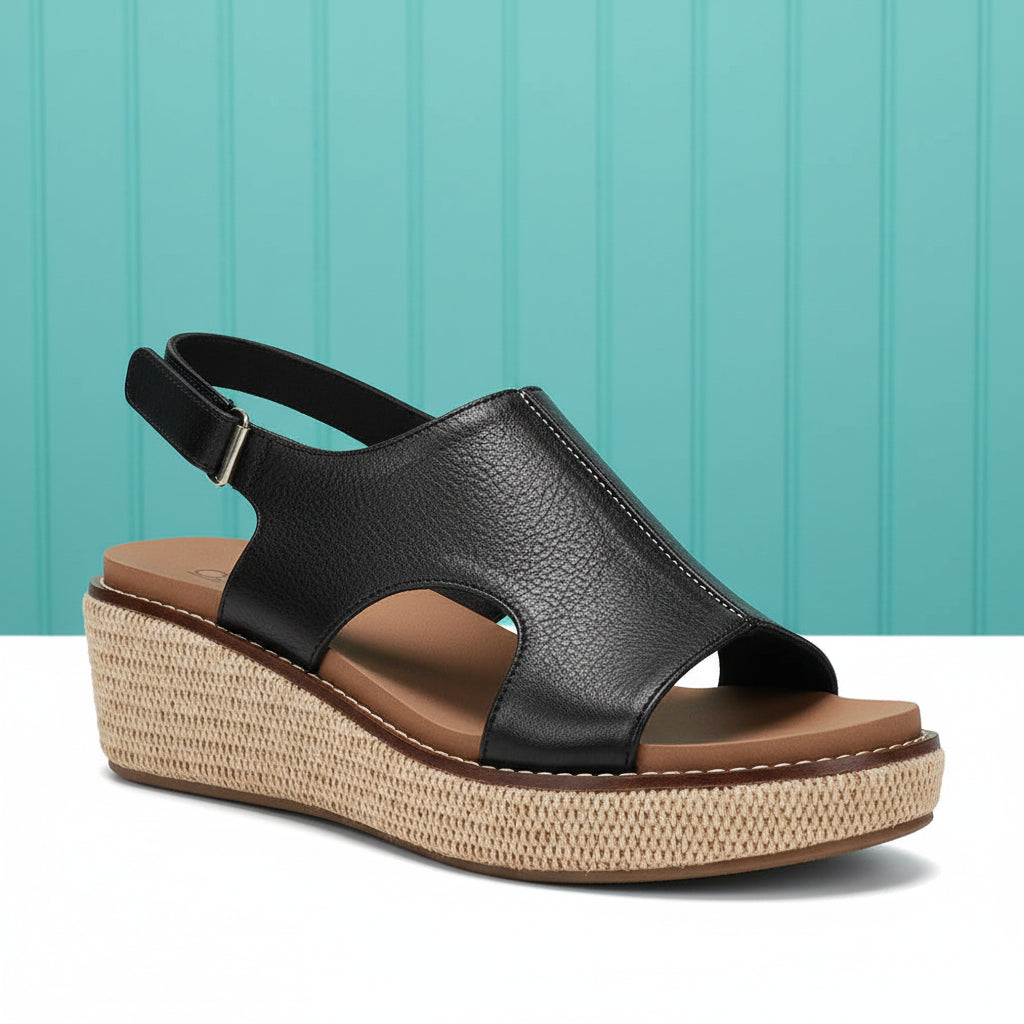 Black sandal with a woven platform on a white background
