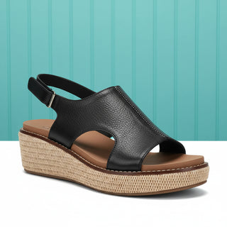 Black sandal with a woven platform on a white background