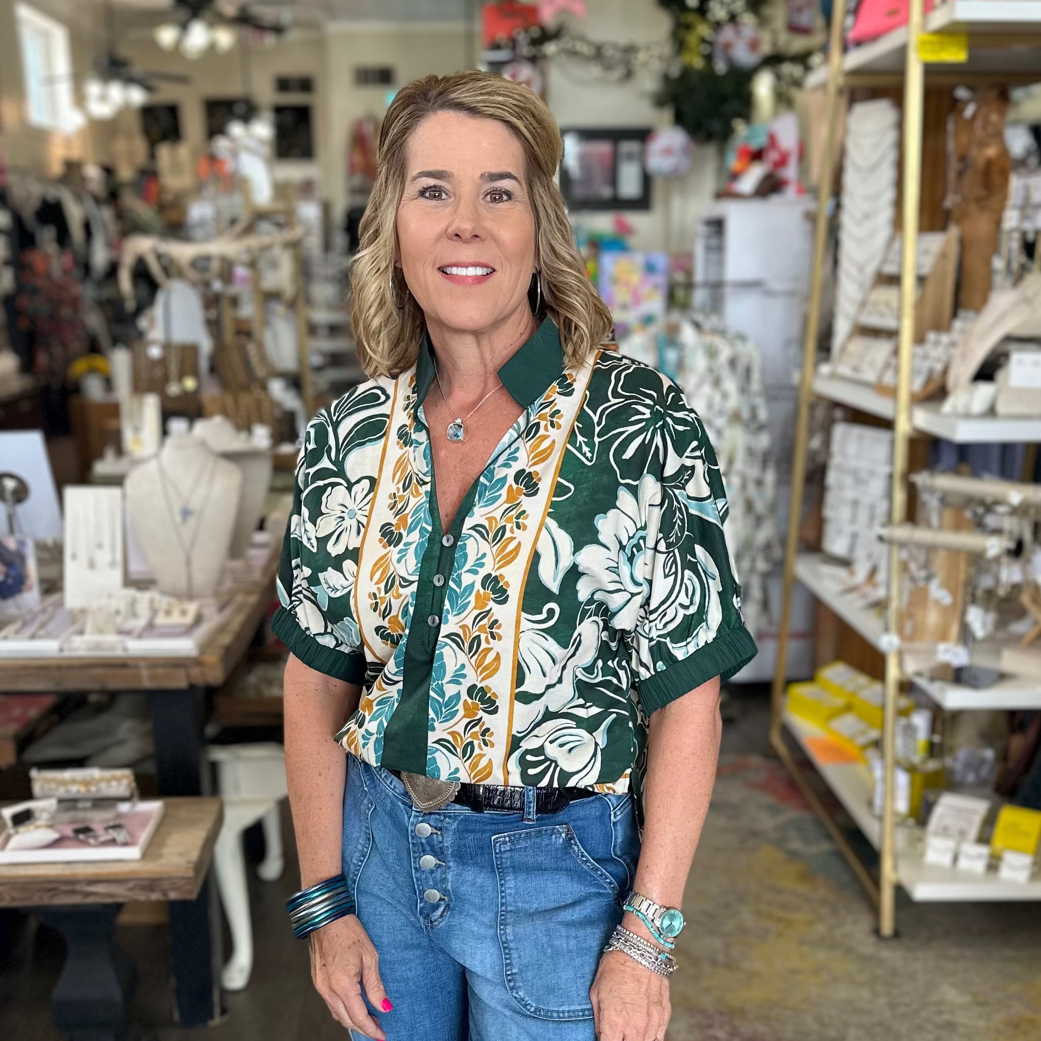 Woman standing in a store with shelves and products in the background