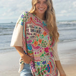 SUNSHINE ON MY SHOULDERS MAKES ME HAPPY, ONE SIZE TEE IN CREAM ON GRIL ON THE BEACH