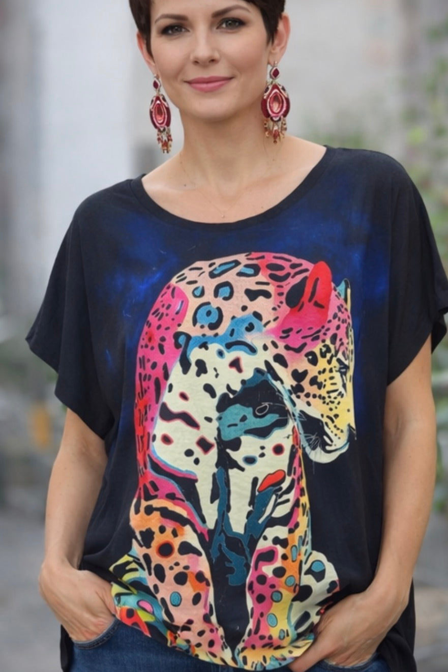 Woman wearing a black t-shirt with a colorful leopard design.