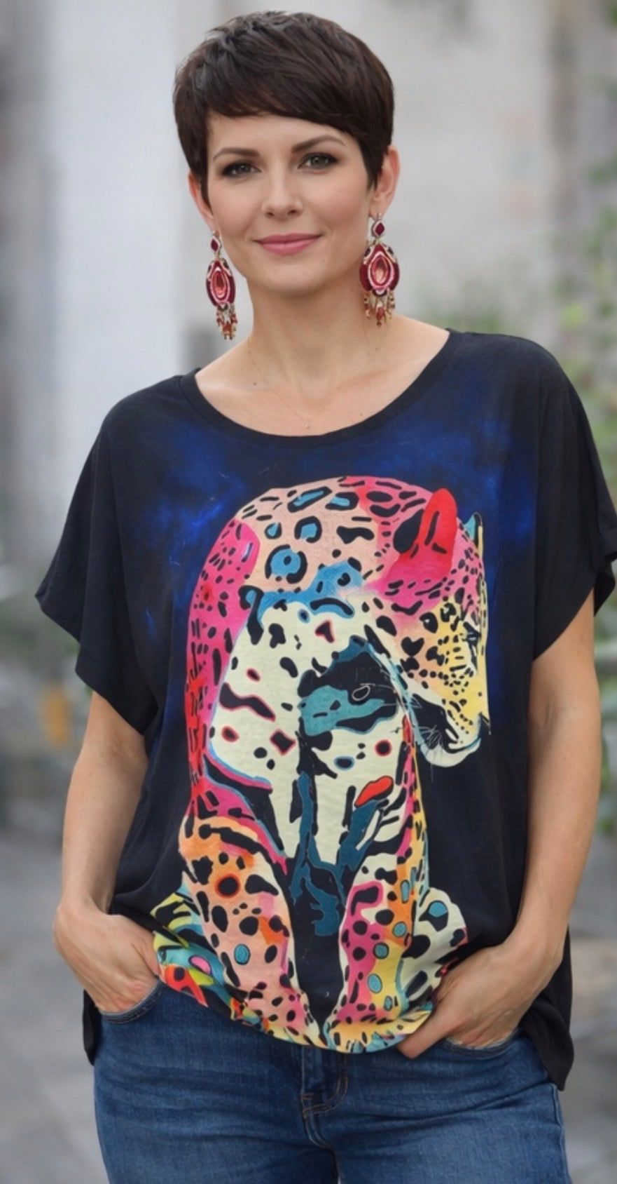 Woman wearing a black t-shirt with a colorful leopard design.