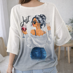 Woman wearing a white t-shirt with a graphic design of a woman holding a glass of wine and sunglasses.