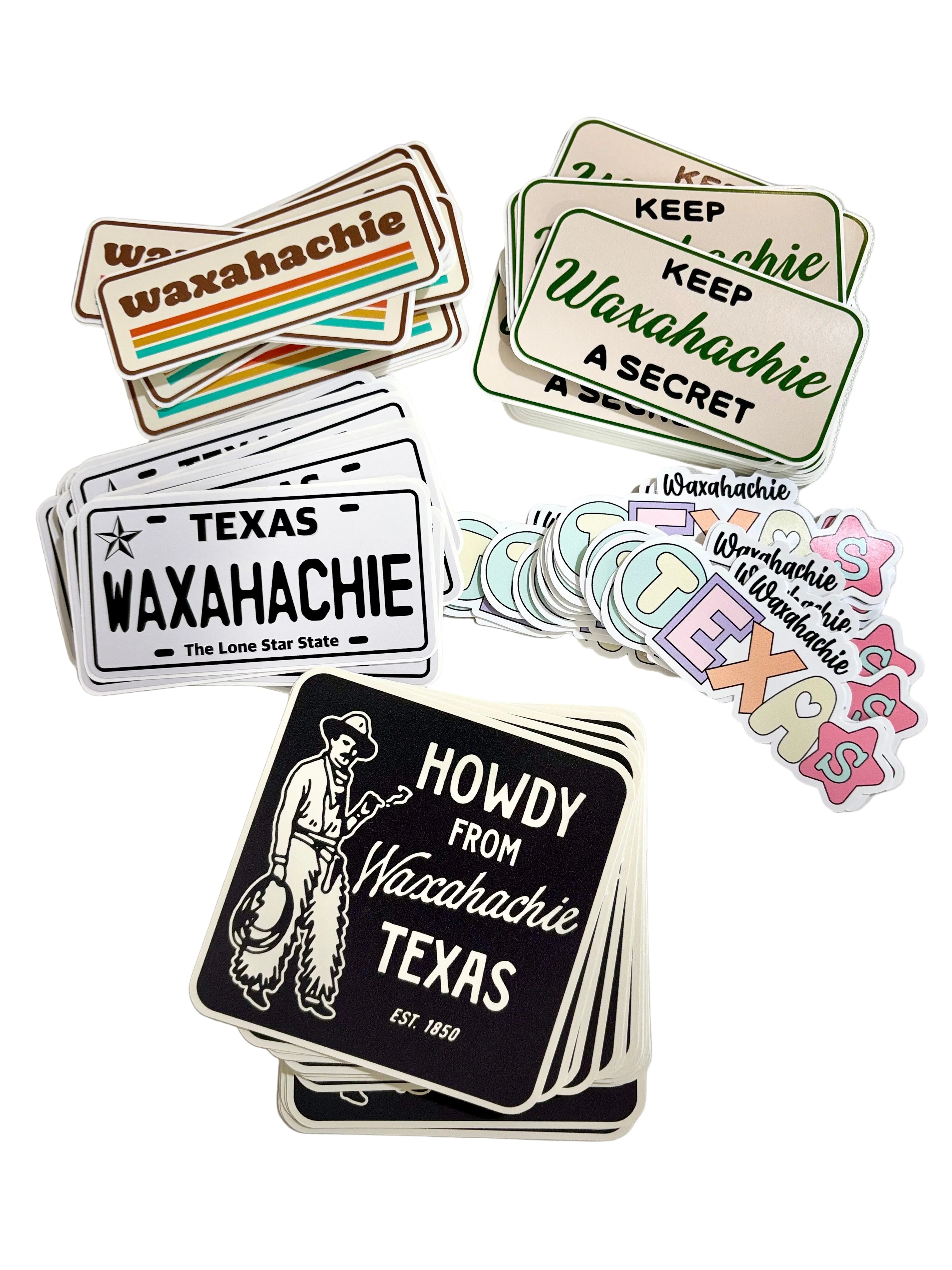 Collection of Waxahachie-themed stickers on a marble surface