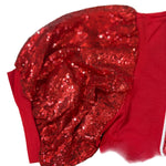 Red sequin headband on a red fabric background