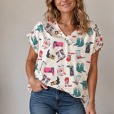 Top with cowboy boots and v neck. Sleeves cuffed.