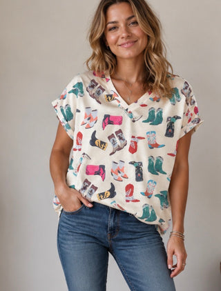 Top with cowboy boots and v neck. Sleeves cuffed.