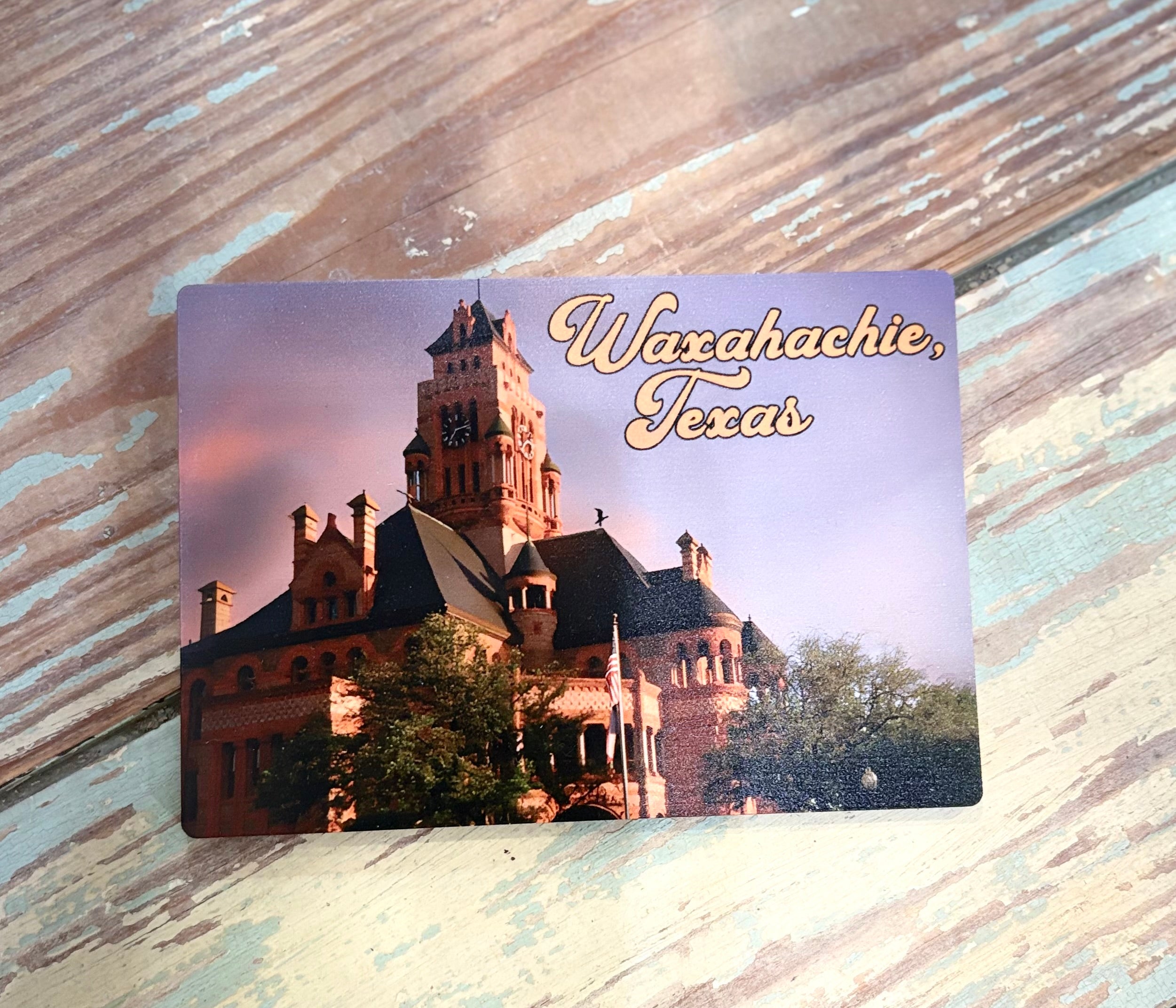 wooden postcard with waxahachie texas courthouse on it.