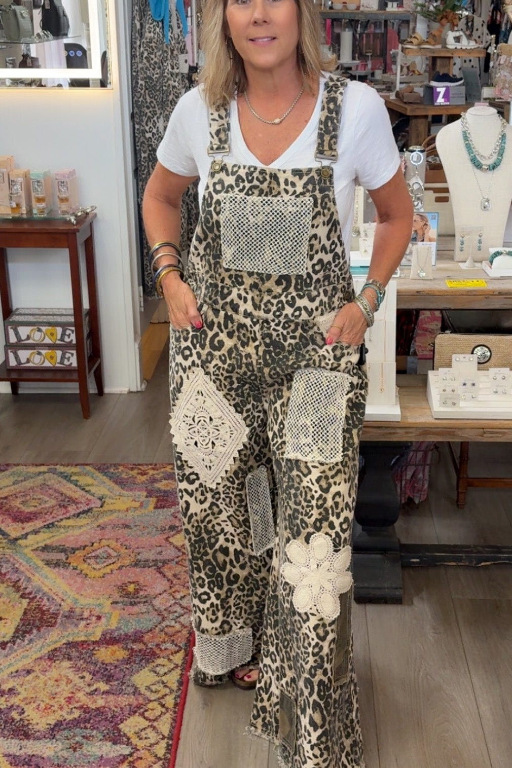 Woman wearing a patterned jumpsuit in a store setting
