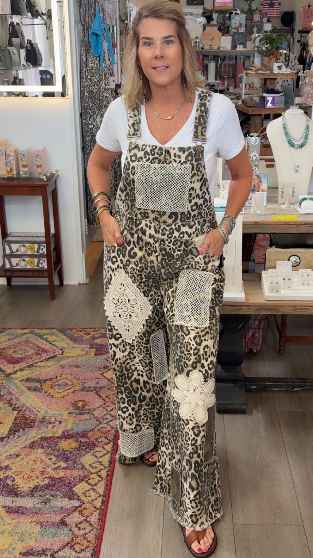 Woman wearing a patterned jumpsuit in a store setting