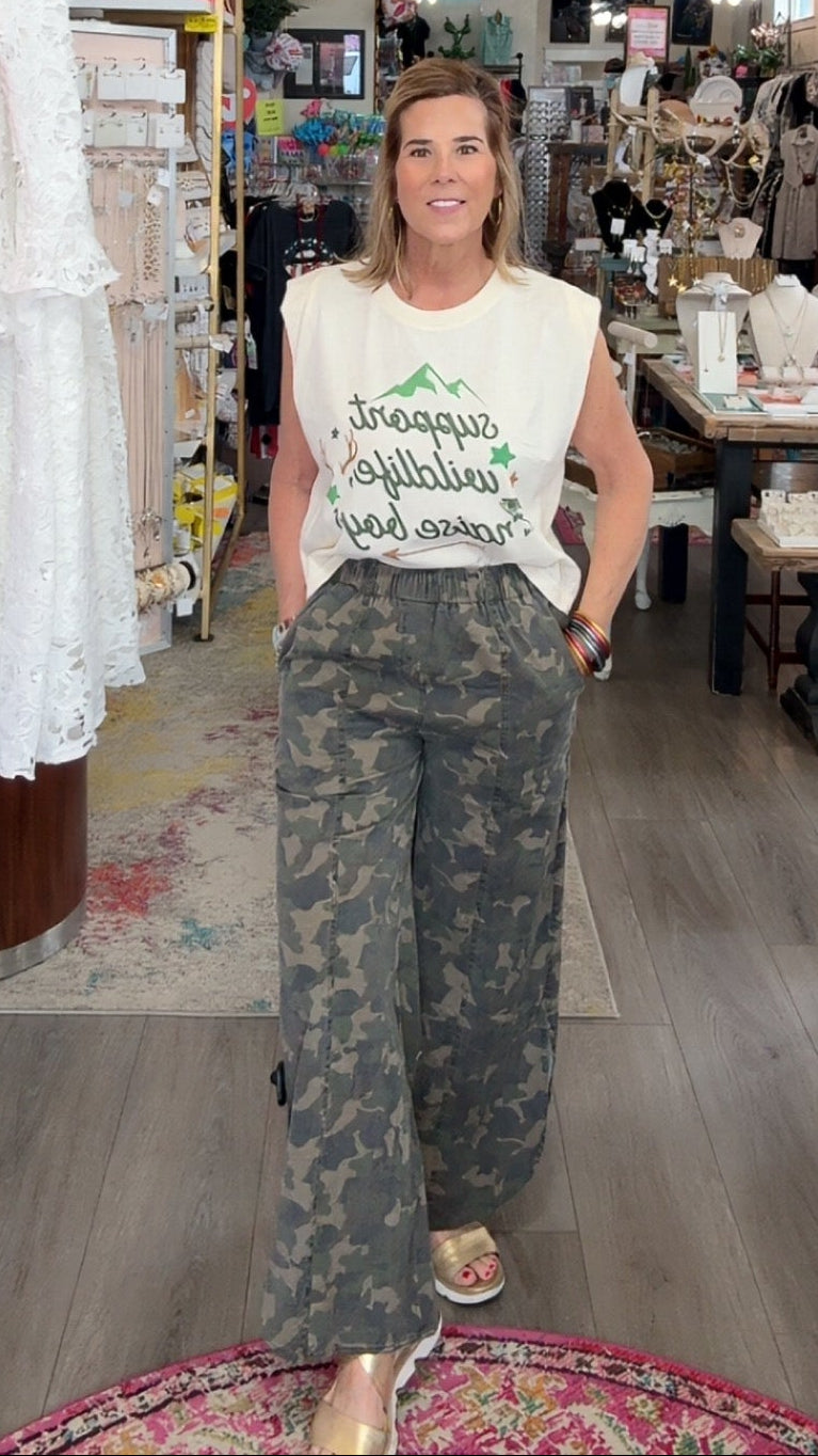 Woman standing in a store with clothing and decor around her