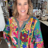 Woman wearing a colorful floral jacket in a store setting