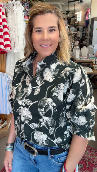 Woman standing in a store with clothing and decor in the background