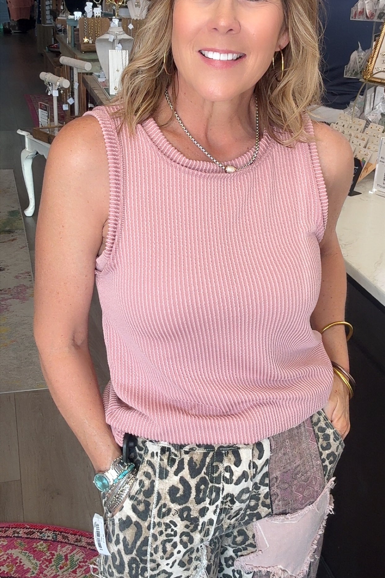 PINK TANK TOP ON MODEL WITH LEOPARD PANTS.