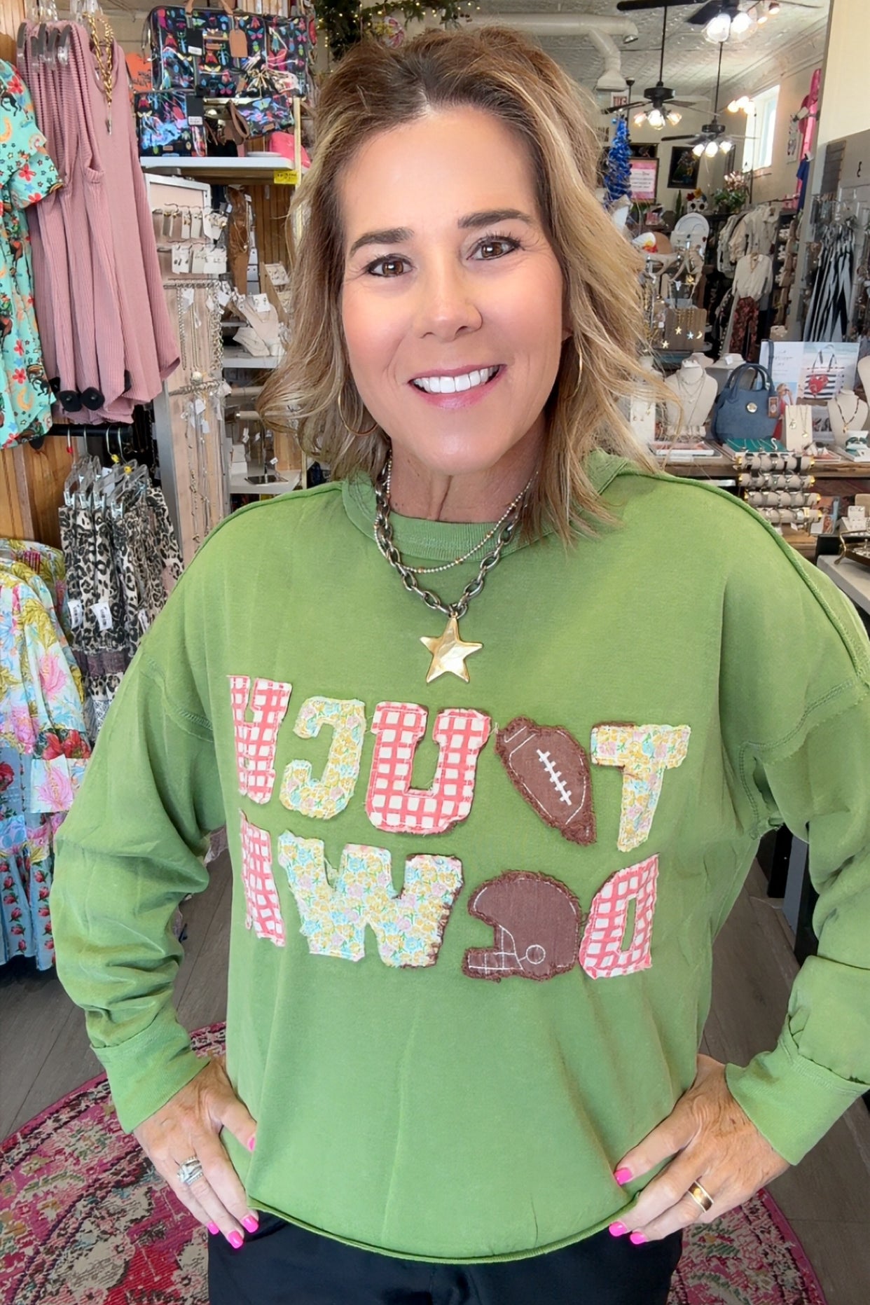 MODEL IN GREEN SWEATSHIRT SAYING TOUCH DOWN
