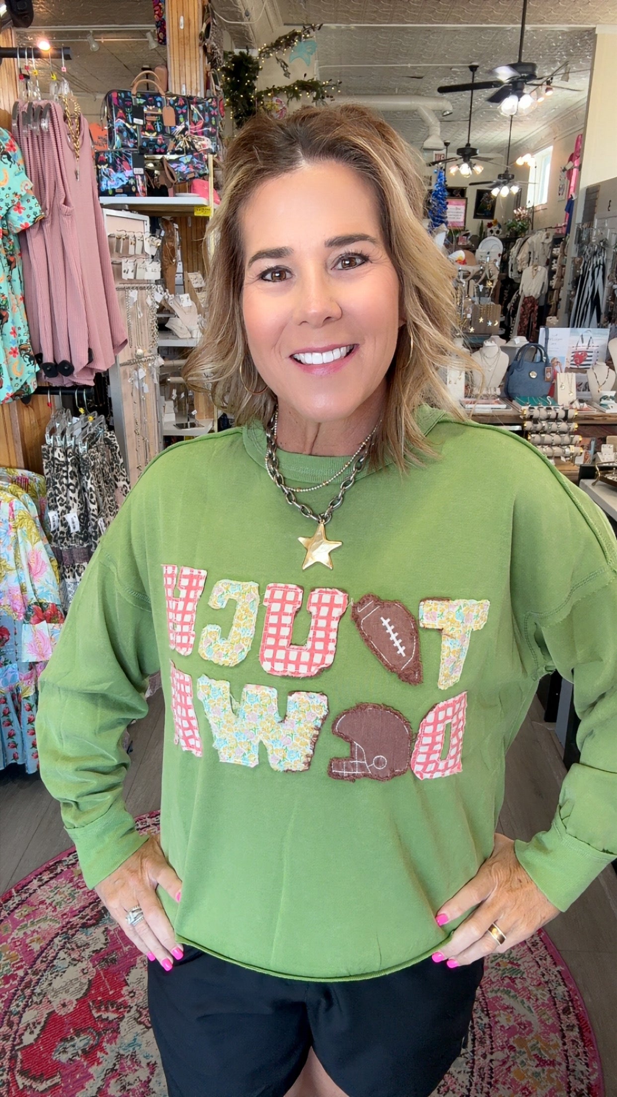 MODEL IN GREEN SWEATSHIRT SAYING TOUCH DOWN
