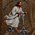 A close-up of a brown leopard-print fabric featuring a printed illustration of Jesus riding a scooter, with the text 'OFF TO FLIP SOME TABLES' and 'JOHN 2:15-16' printed on it.
