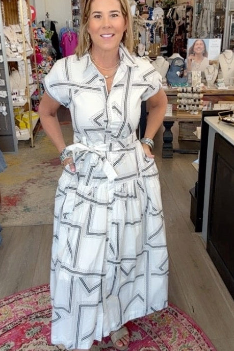 lady in geo pattern dress and wedges in a boutique.