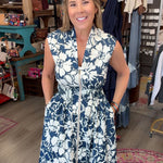 LADY in navy floral sleeveless dress with zipper front in a boutique