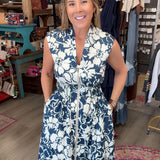 LADY in navy floral sleeveless dress with zipper front in a boutique
