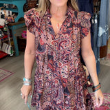 lady in floral paisley dress with ruffle sleeve in a boutique