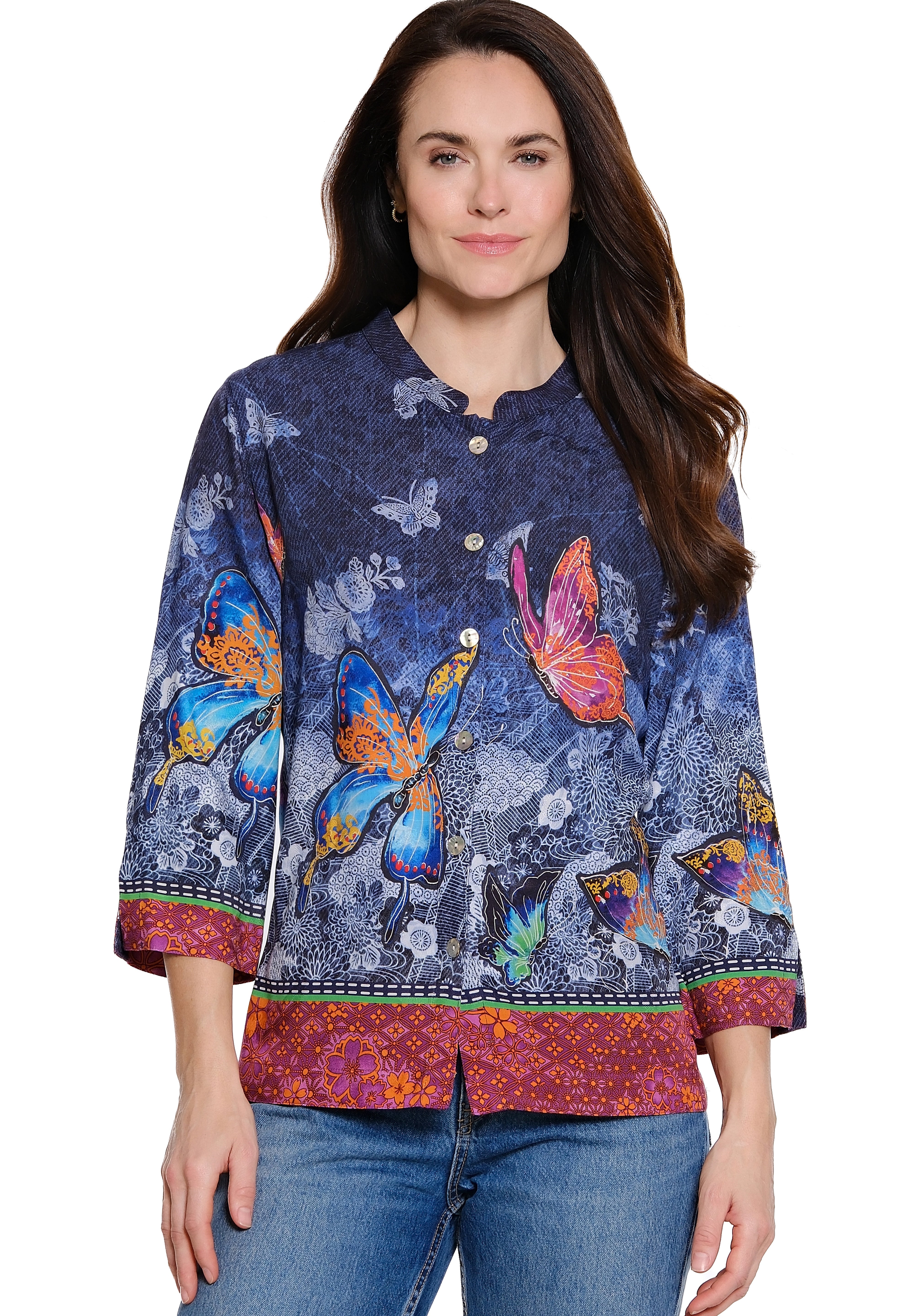 Woman wearing a colorful butterfly-patterned shirt on a white background